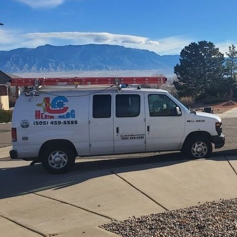 A modern gray residential air conditioner unit installed on a concrete slab next to a home in Tulsa, OK.